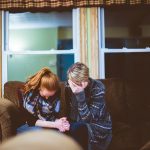 A mother and daughter holding hands and crying in grief Why is grief so hard?