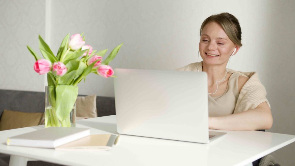 Woman sitting comfortably at her laptop for an online therapy session