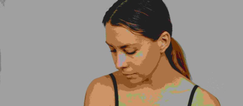 Woman hanging her head low, expressing shame and self-consciousness