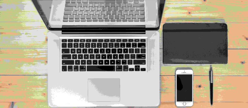 Neatly arranged laptop, mobile phone, tablet and pen on a desk, symbolising control and perfectionism